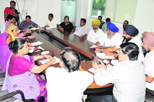 Municipal Commissioner Uma Shankar Gupta interacts with former municipal councillors and traders during a meeting held in connection with regularisation of unauthorised colonies, in Bathinda on Monday. 