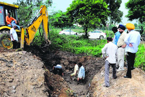 BSNL workers restore telephone lines near the Housing Board light point at Mani Majra on Monday. 
