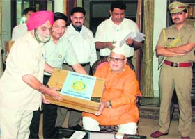 Governor Aziz Qureshi hands over water purifiers to heads of various education institutions in Dehradun on Monday