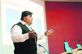 Sunil Miglani, director of Skill Track, addresses the audience during a workshop on stocks and share market held on the NIT campus in Kurukshetra