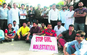 NGO volunteers and locals took to streets and blocked the road to the bus stand at Reasi on Monday. 
