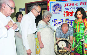 Dignitaries light a traditional lamp to inaugurate the Hindi Fortnight celebrations at Radio Kashmir in Jammu on Monday. 