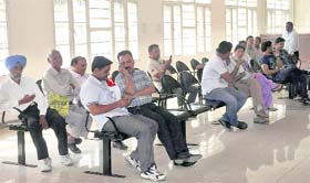 Applicants wait for getting their work done as there was a power failure and no backup was available at the new revenue office building in Jalandhar on Monday.