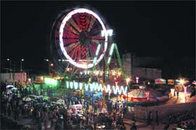Glittering lights and swings at the site where the Sodal Mela is to be held in Jalandhar.