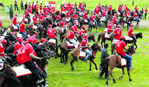 Pony-wallas take part in a race at the Gulmarg tourist resort on Monday. 