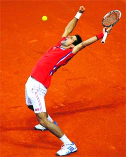 Thriving in a fervent home support, Novak Djokovic outclassed Canadas Milos Raonic 7-6(1) 6-2 6-2 to level the tie 2-2, before Janko Tipsarevic sealed the win for Serbia.