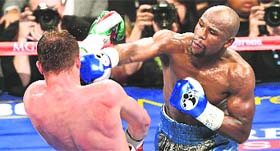 Floyd Mayweather outboxed Saul Canelo Alvarez to take the Mexicans WBA and WBC super welterweight titles by a majority decision in Las Vegas on Saturday night.