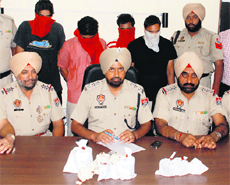 Police officials with the four persons arrested with narcotics in Amritsar on Tuesday. 
