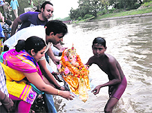 Devotees immerse an idol of Lord Ganesha in the Sirhind Canal in Bathinda on Tuesday