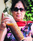 A resident of Sector 34 shows a bottle filled with muddy water on Tuesday. Tribune photo: Manoj Mahajan