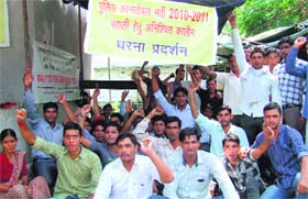 Sacked policemen stage a demonstration demanding their reinstatement in Dehradun on Tuesday.