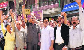 BJP MLA Col Inder Singh and supporters raise slogans against former minister and Congress leader Rangeela Ram Rao during a function at Sarkaghat in Mandi on Tuesday.