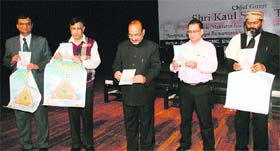 Health Minister Kaul Singh Thakur (centre) releases a booklet on holistic health at Dr RP Government Medical College in Tanda.