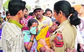 A policewoman tries to console relatives of the victim at BRS Nagar in Ludhiana on Tuesday.