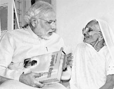 Narendra Modi with his mother Hiraba, who gifted him a copy of the Gita on his 64th birthday, in Gandhinagar on Tuesday. 