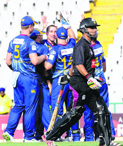 Otago players celebrate the fall of a Faisalabad Wolves batsman in Mohali on Tuesday. 
