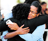 Women embrace after meeting loved ones who were at the Washington Navy Yard