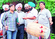 Drummers outside the office of the Industries Department during a recent drive. The water and sewerage wing will realise the dues on the lines of the House Tax Department