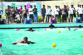 Participants take part in a swimming competition organised by the National Disaster Response Force in Bathinda.
