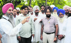 Supporters of Dr Manjeet Singh Jaura interact with each other in Bathinda.