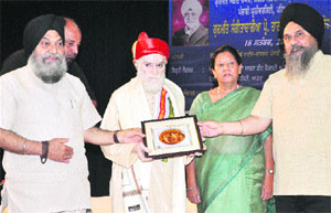 Vice-Chancellor of Punjabi University Jaspal Singh honours Prof SB Sharma, former head of the music department, Dyal Bagh University, Agra, during a programme on the university campus in Patiala on Wednesday.