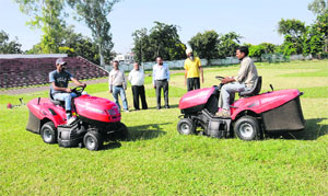 Members of the Chandigarh Athletics Association inspect the new Hi-Tech Ride-on mower tractor in Chandigarh on Wednesday