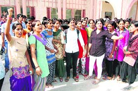 Students protest against registration of a case against some students of Chaudhary Devi Lal University in Sirsa on Wednesday