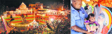 The Sodal temple lit up with decorative lights as the Baba Sodal Mela starts; and (right) a devotee offers prayers in front of the statue of the deity with his child in Jalandhar on Wednesday evening. 