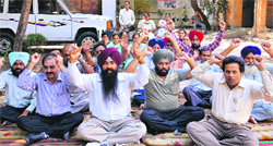Office-bearers and members of the Punjab Health Department Subordinate Offices Clerical Association hold a protest outside the Civil Surgeons office in Ludhiana on Wednesday; and (below) an office wears a deserted look due to the strike. Photos: Inderjeet Verma