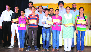 Office-bearers of the Shriram Foundation with children of truck drivers and transporters after giving them educational assistance. A Tribune photograph