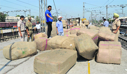Officials of the Excise and Taxation Department seize parcels from the Ludhiana railway station on Wednesday. Photo: Inderjeet verma