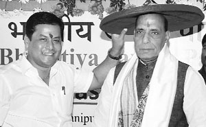 BJP chief Rajnath Singh is felicitated with the traditional Assamese Gamocha and Japi (hat) by party state president Sarbananda Sonowal in Guwahati. 