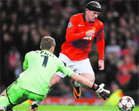 Manchester United's Wayne Rooney goes past Bayer Leverkusen's goalkeeper Bernd Leno during their Champions League match in Manchester on Tuesday.  Reuters