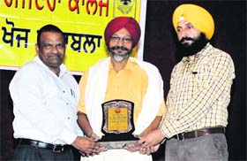 Principal Vijay Goyal and prof Gurjit Singh Mann honour Dr Buta Singh Brar, head of the regional centre, Punjabi University, during a talent hunt programme at Government Rajindra College in Bathinda on Thursday