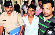 Kshitij Goel with one of his relatives at the Sector 14 police station in Panchkula on Thursday