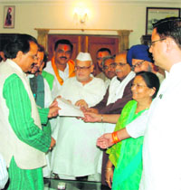 A delegation of state BJP MLAs and leaders submit a memorandum to Governor Aziz Qureshi at Raj Bhavan in Dehradun on Thursday.