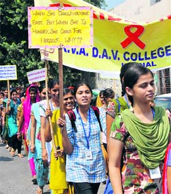 Students of KVA DAV College for Women hold an awareness rally on women empowerment in Karnal on Thursday.
