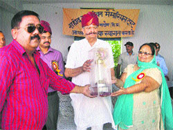 Power Minister Sujan Singh Pathania receives a memento at a function at Bada in Hamirpur district on Thursday.