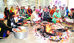 Kashmiri Pandits pray during a havan puja at a temple in Anantnag on Thursday
