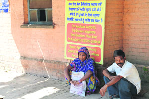 Visitors wait outside the Civil Surgeon's office in Ludhiana on Thursday