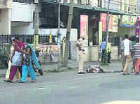 A policeman stands near an injured man who was hit by a vehicle in Ludhiana on Thursday.