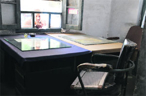 a man stares at an empty chair during a strike by the health staff. 