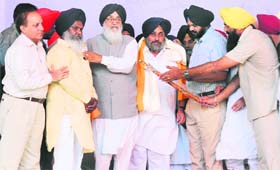CM Parkash Singh Badal (third left) and his deputy Sukhbir Badal (third right) being honoured at the Chhapar Mela in Mandi Ahmedgarh on Thursday