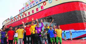 Children pose in front of a giant replica of the Titanic that doubles up as the entrance to a fair that began at the Sector 34 exhibition ground in Chandigarh on Friday.