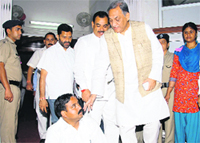Chief Minister Vijay Bahuguna persuades Bhim Lal Arya, BJP MLA from Ghansali, into ending his protest in Dehradun on Friday. Tribune photo: Vinod Pundir 
