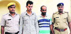 Nidhis brother Sunny (second from left), and Mahesh, the driver of the vehicle used in the crime, being produced in the court at Rohtak on Friday. 