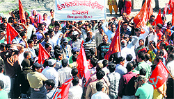 Workers of a mineral water factory hold a protest at Raison in Kullu on Friday