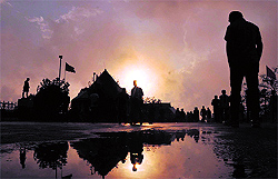 People walk after rain in Shimla on Friday