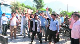 Residents block Reasi Jyotipuram road on Friday.
