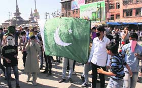 Activists of the moderate faction of the Hurriyat Conference carry a Pakistani flag during a protest in Srinagar on Friday.